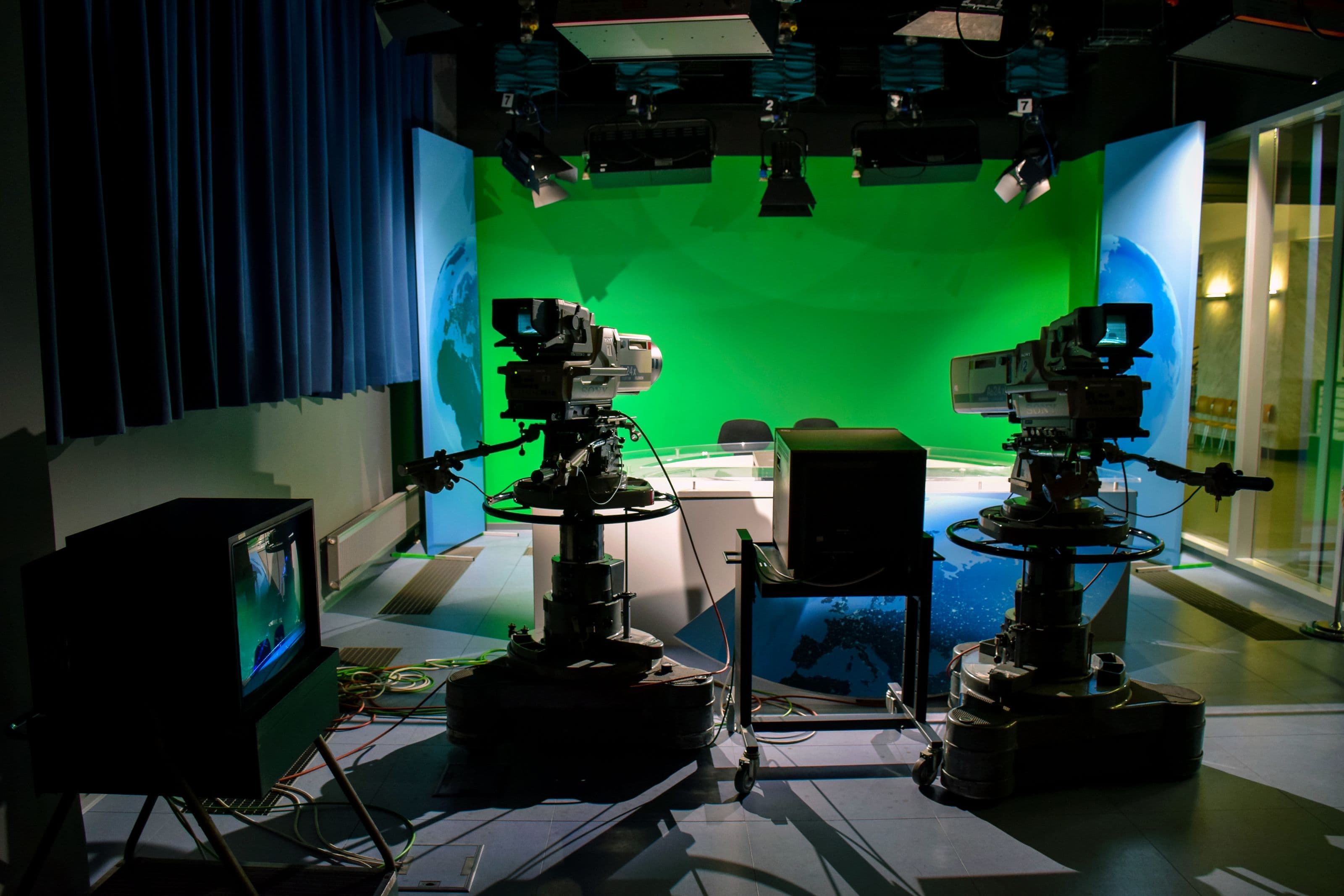 Television broadcast studio with cameras and lighting rigs